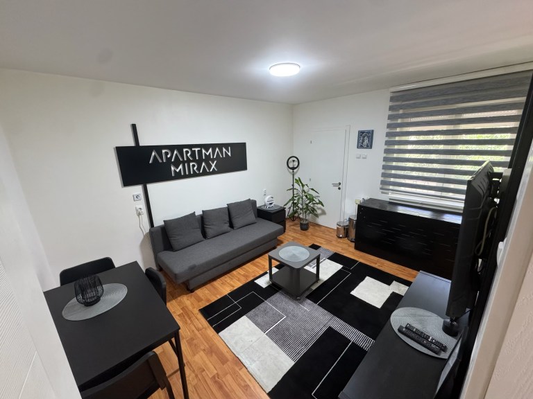 MIRAX living room in Kraljevo with a sofa, dining table and TV