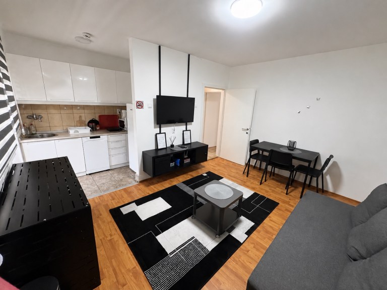 White kitchen and dining table connected to the MIRAX living room